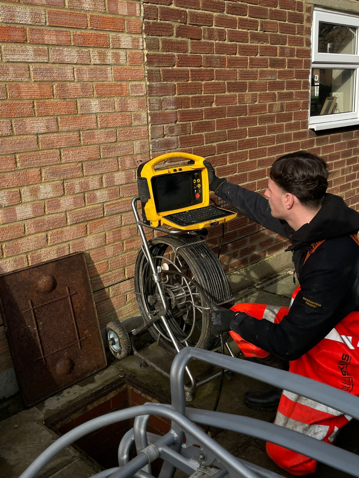 CCTV drain camera reel and monitor at an open manhole